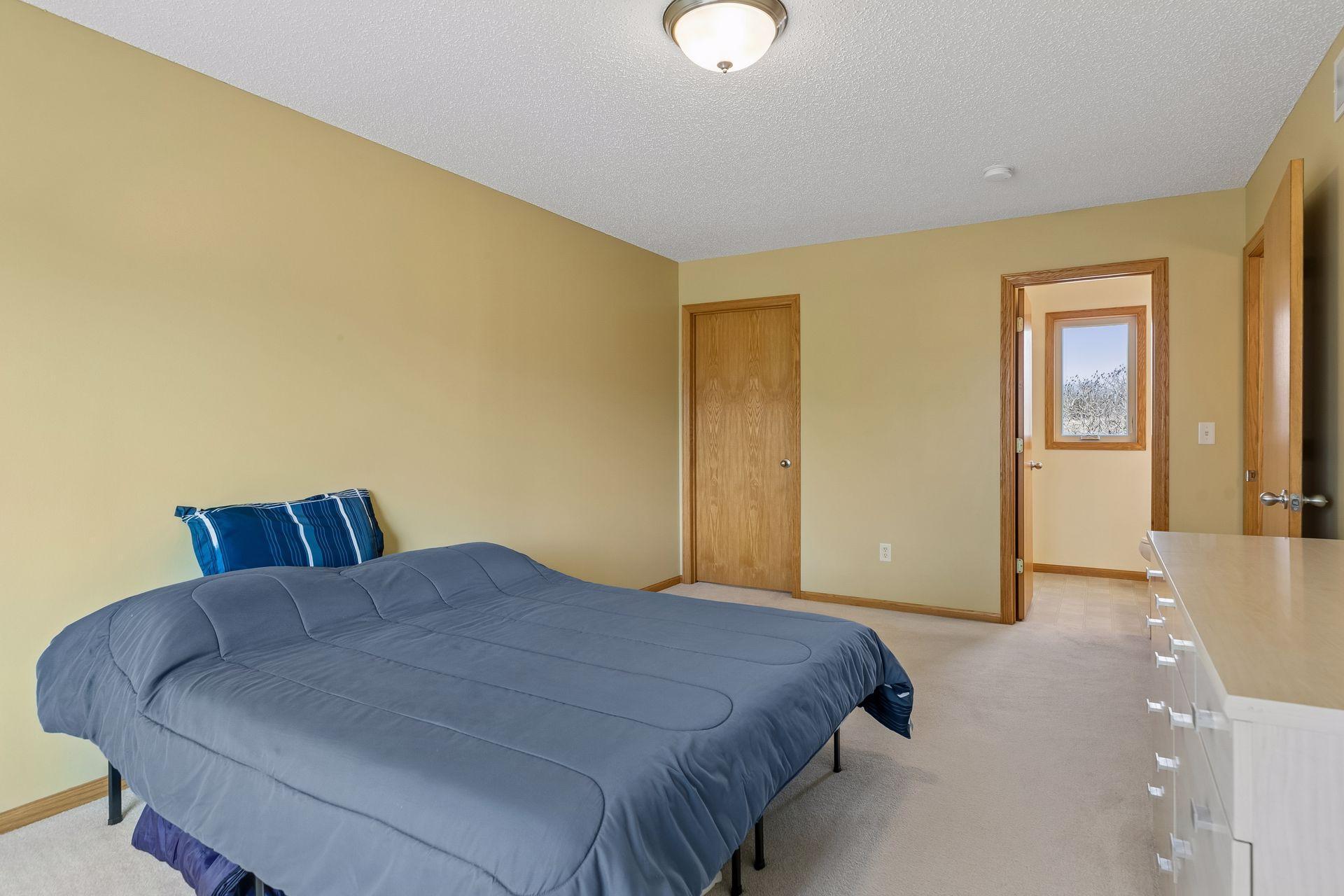 49 Windsor Wood Path - Primary suite with 3/4 bathroom and walk-in closet.