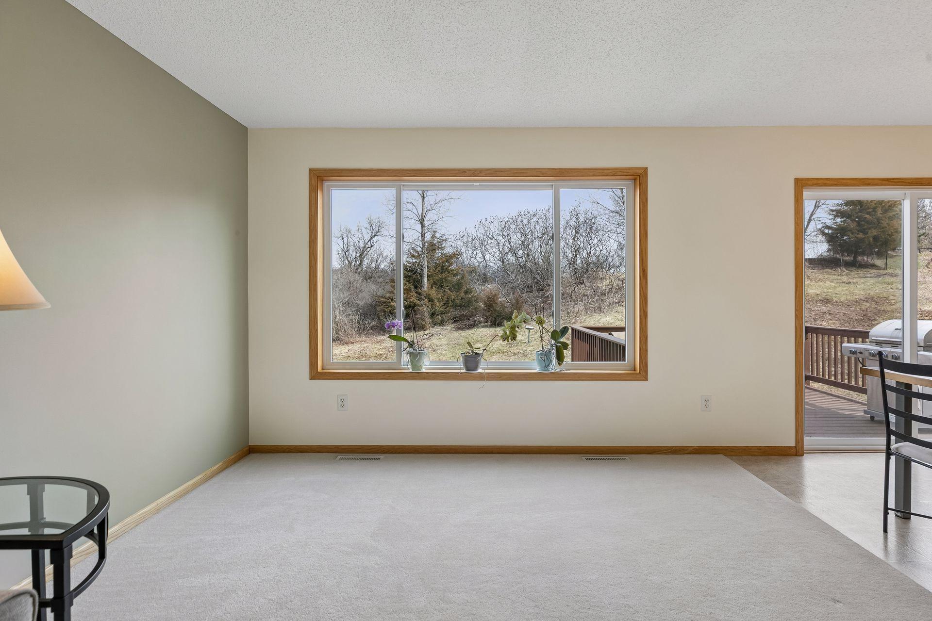 49 Windsor Wood Path - Living room features large new windows and a nearby dining room patio door allowing in natural light on both sides and a nice view of the nearly 1/2 acre lot.