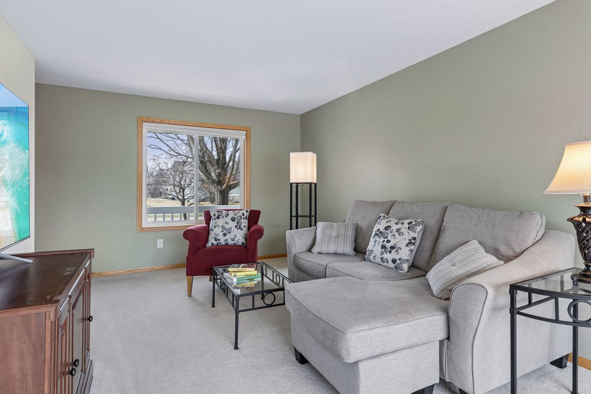 49 Windsor Wood Path - Living room features large new windows and a nearby dining room patio door allowing in natural light on both sides and a nice view of the nearly 1/2 acre lot.