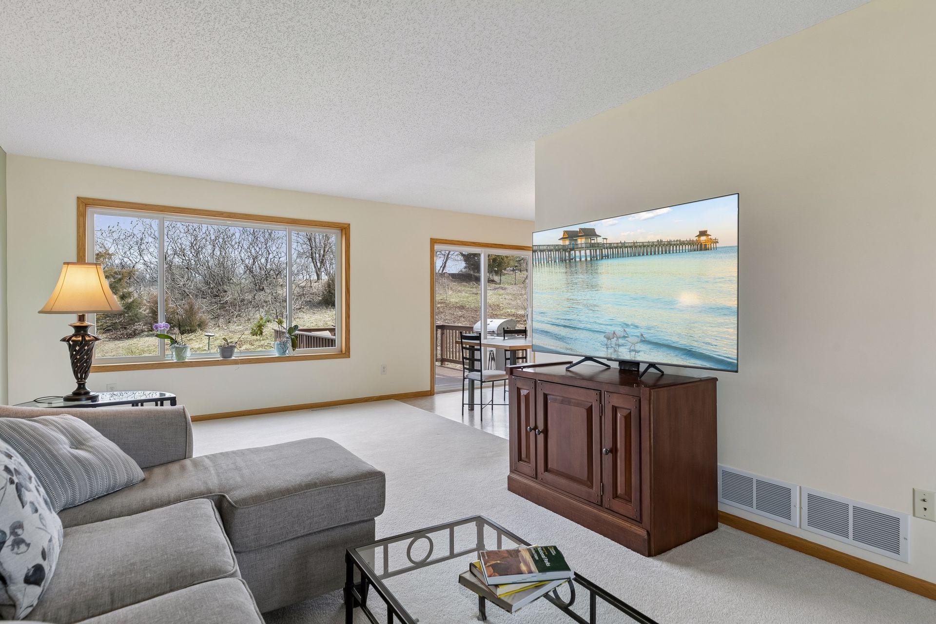 49 Windsor Wood Path - Living room features large new windows and a nearby dining room patio door allowing in natural light on both sides and a nice view of the nearly 1/2 acre lot.