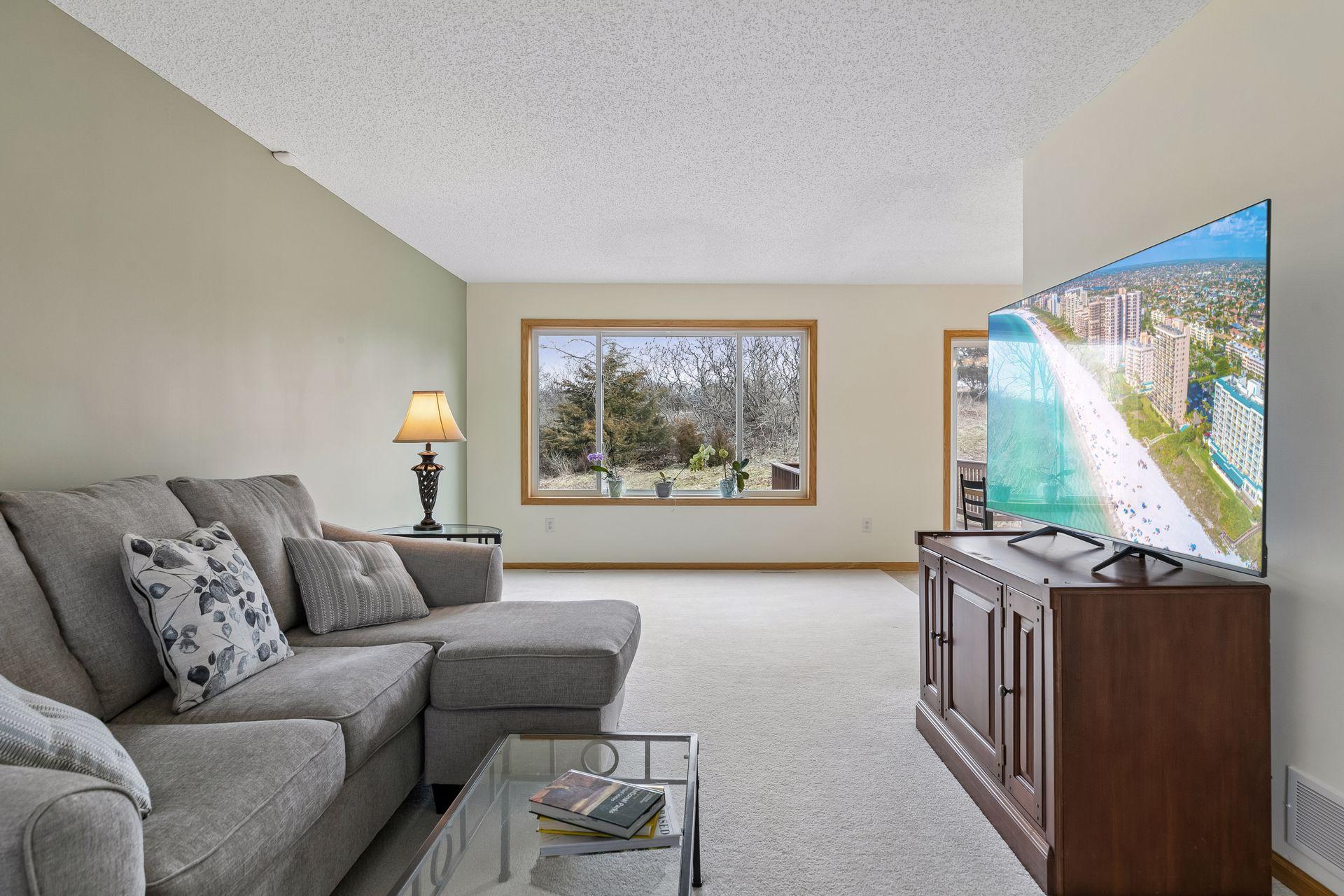 49 Windsor Wood Path - Living room features large new windows and a nearby dining room patio door allowing in natural light on both sides and a nice view of the nearly 1/2 acre lot.