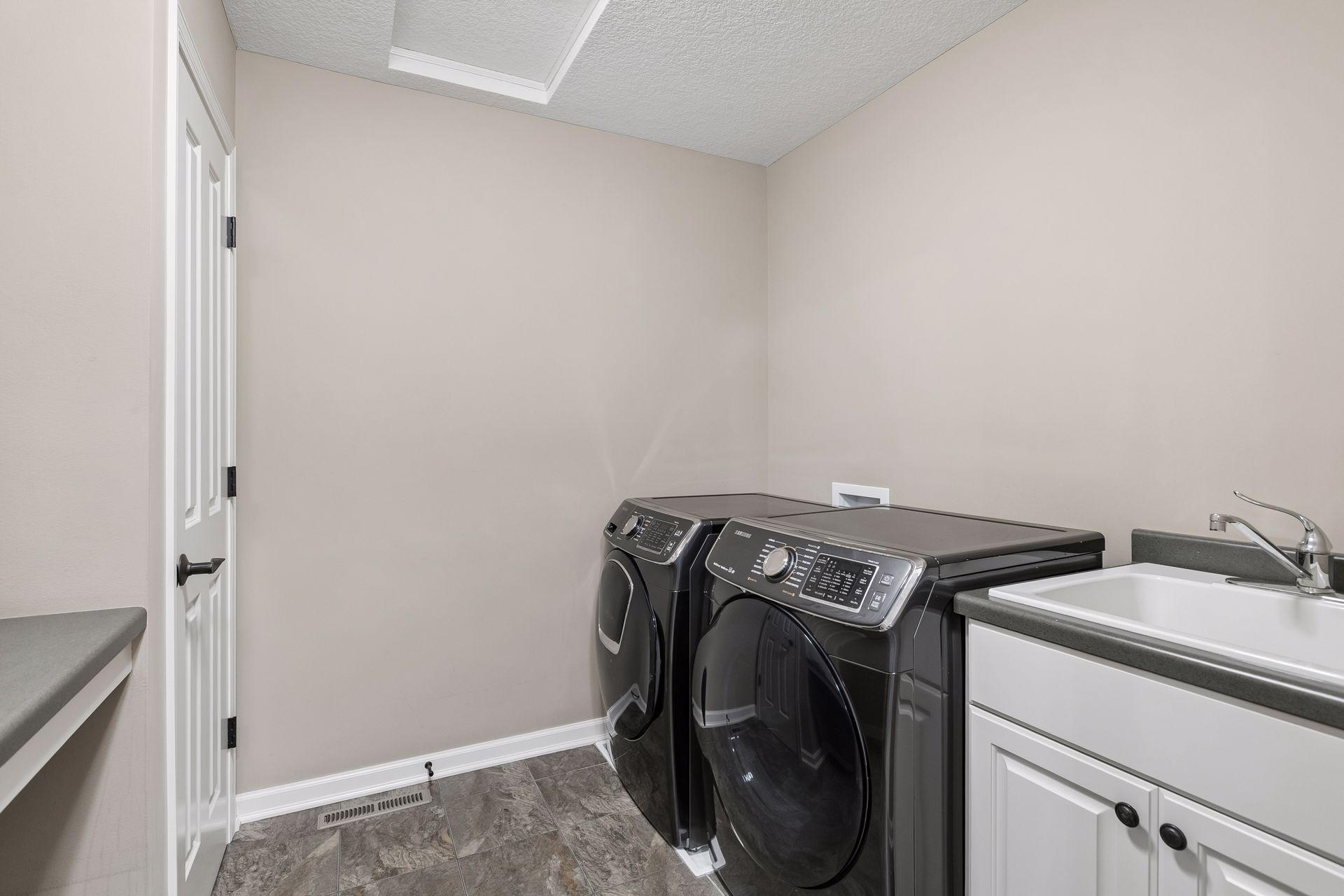 Upper level laundry room with closet and folding counter