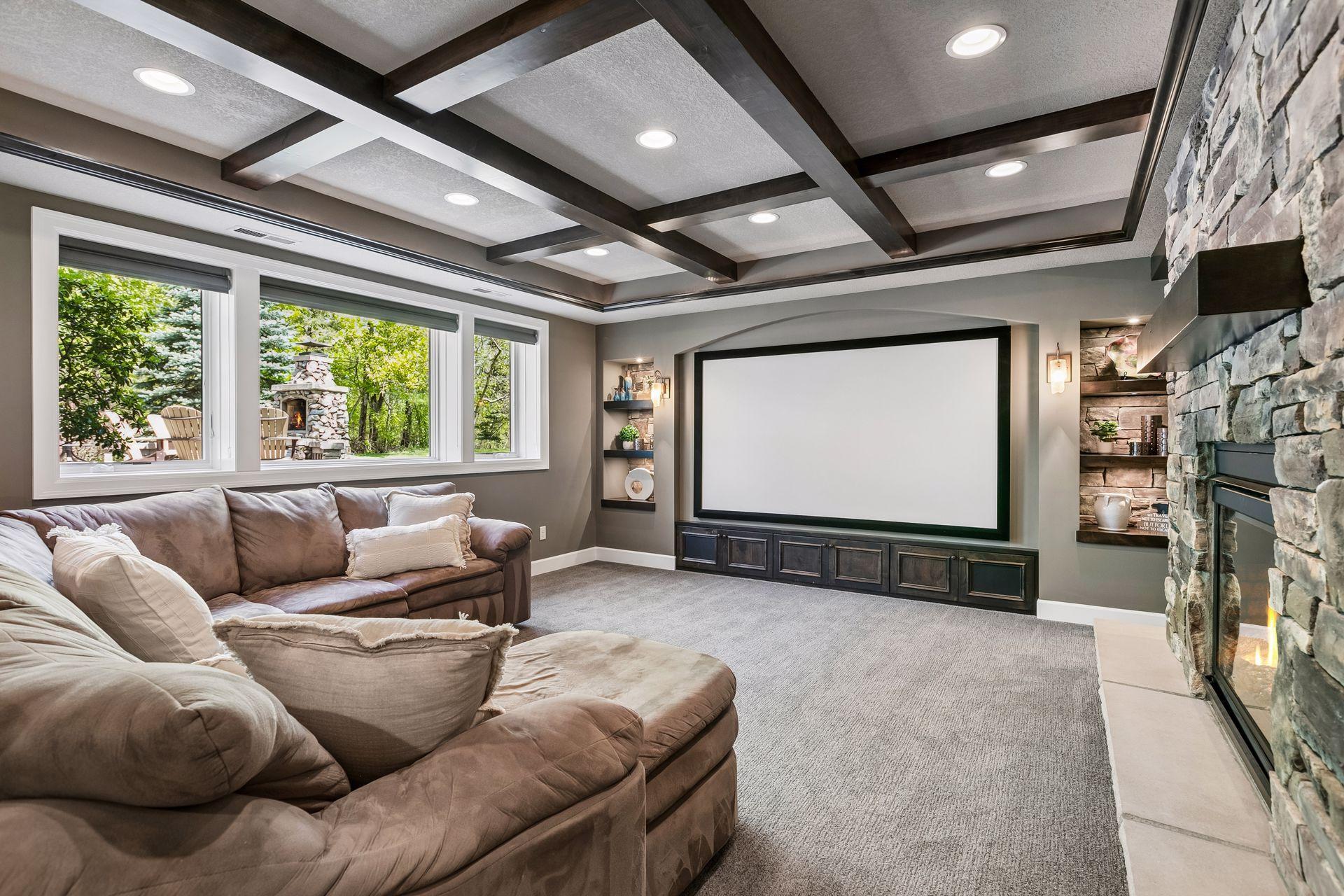 Lower level theater room with audio-perforated 110" screen