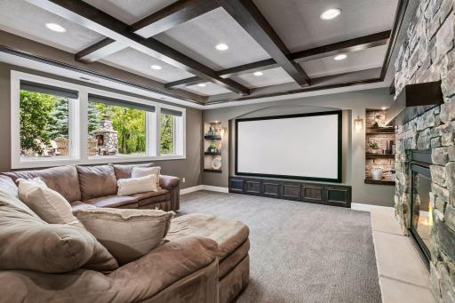 Lower level theater room with audio-perforated 110" screen