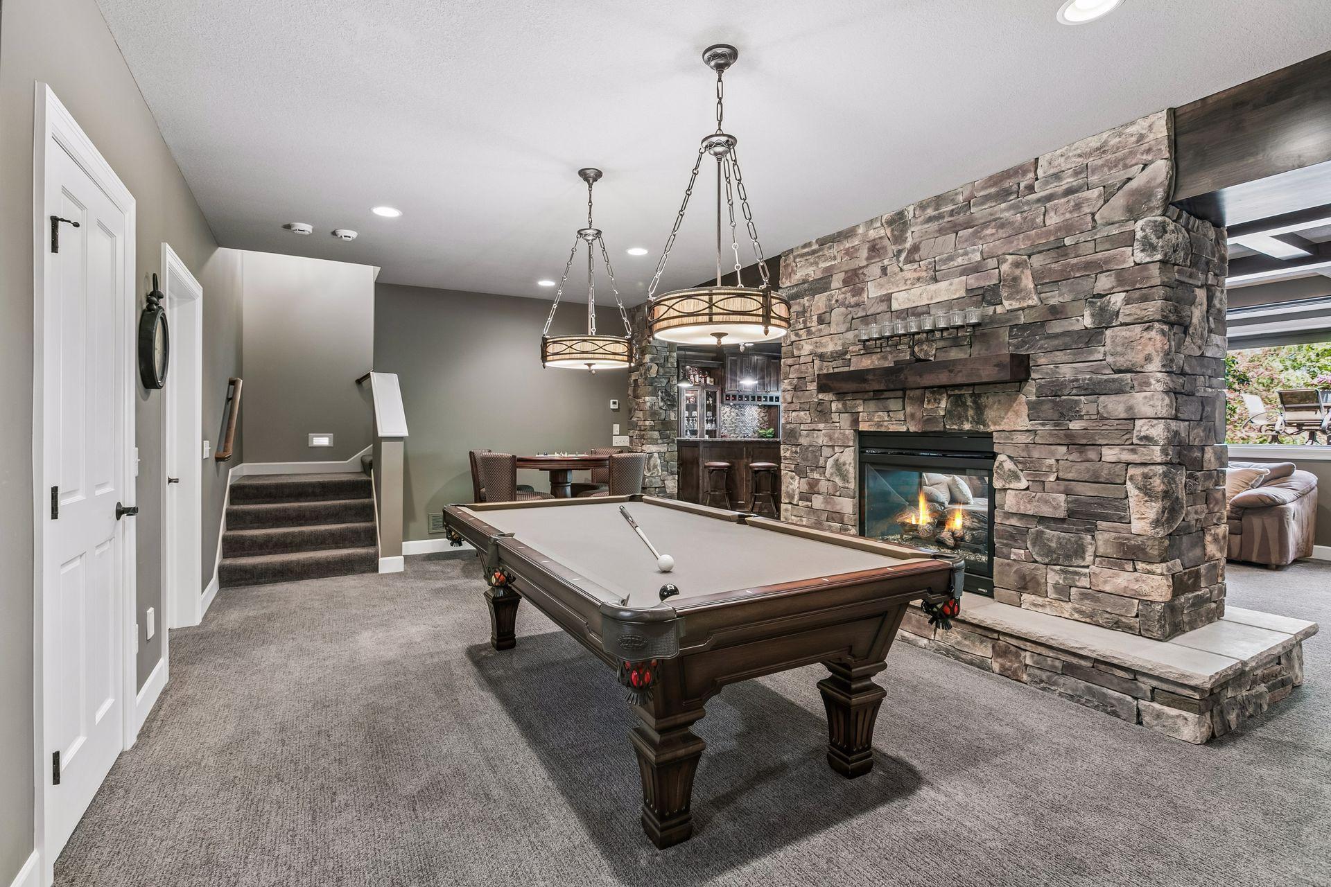 Game room with floating fireplace and room for a pool table and game table