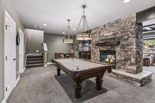Game room with floating fireplace and room for a pool table and game table