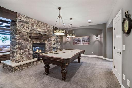 Floating stone fireplace between game room & theater room