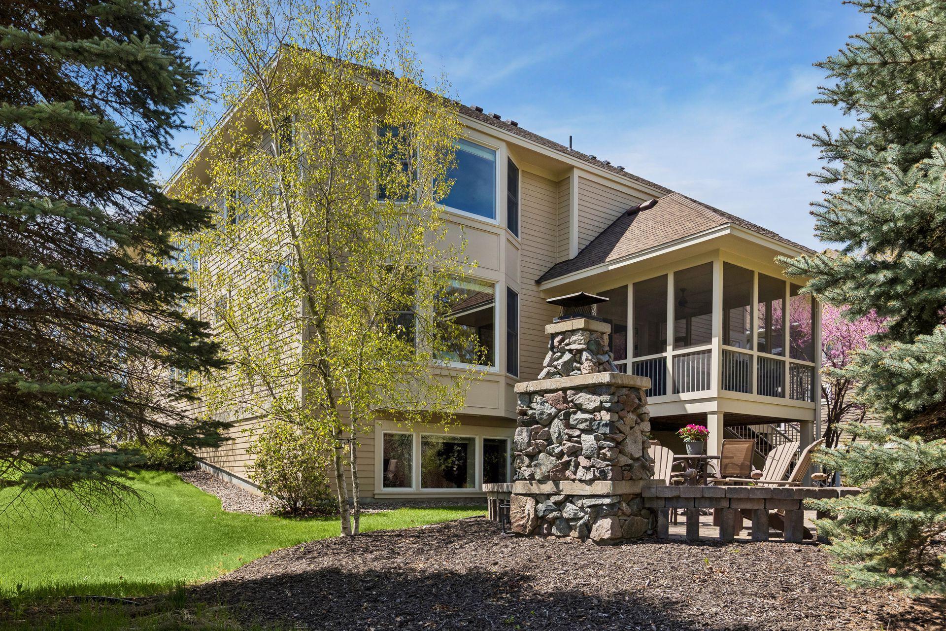 Enjoy the backyard from the screen porch or the patio with stone fireplace