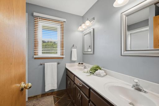 Primary bathroom with double-sink vanity and natural light