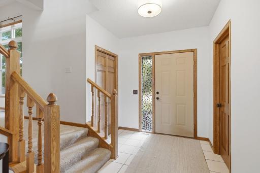 Bright front entry with natural woodwork and easy access to main-level spaces