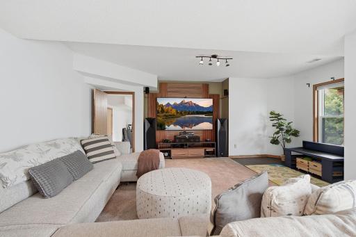 Spacious finished lower-level amusement room with flexible space for gathering or recreation