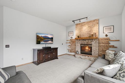 Cozy family room with fireplace, neutral finishes, and abundant natural light