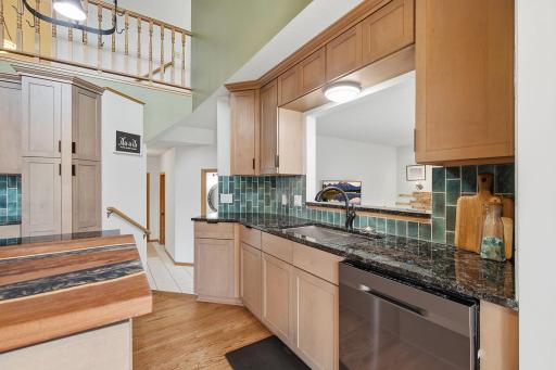 Kitchen pass-through keeps the space open to the surrounding living areas