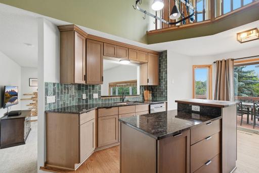 Updated kitchen with center island, tile backsplash, and functional workspace
