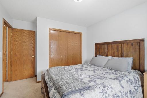 Upper-level bedroom with closet space and natural wood trim