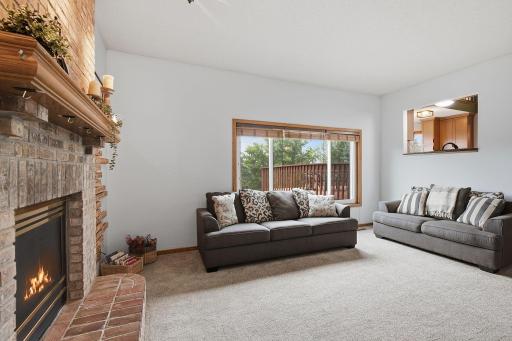 Main-level family room with backyard views and a warm fireplace focal point