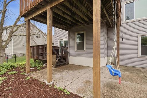 Covered patio beneath the deck offers shaded outdoor space