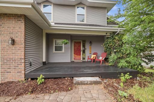 Covered front porch with charming entry and seating area