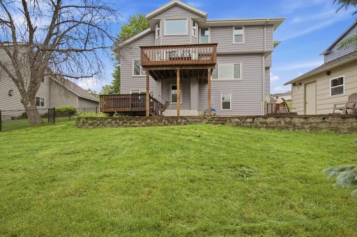 Backyard view highlighting the deck, patio, and usable lawn space