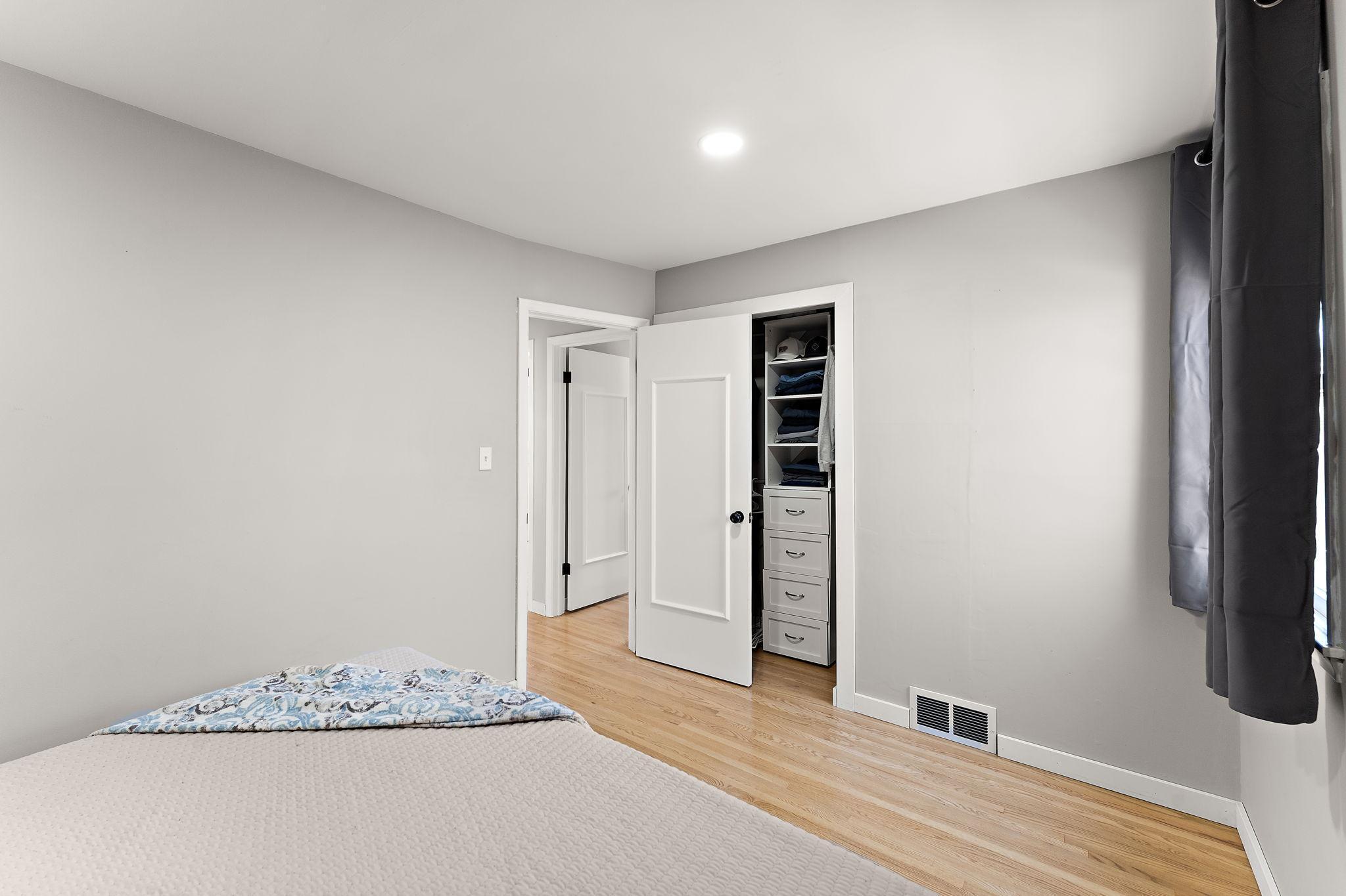 The main floor primary bedroom has a closet space tucked behind the open bedroom door.