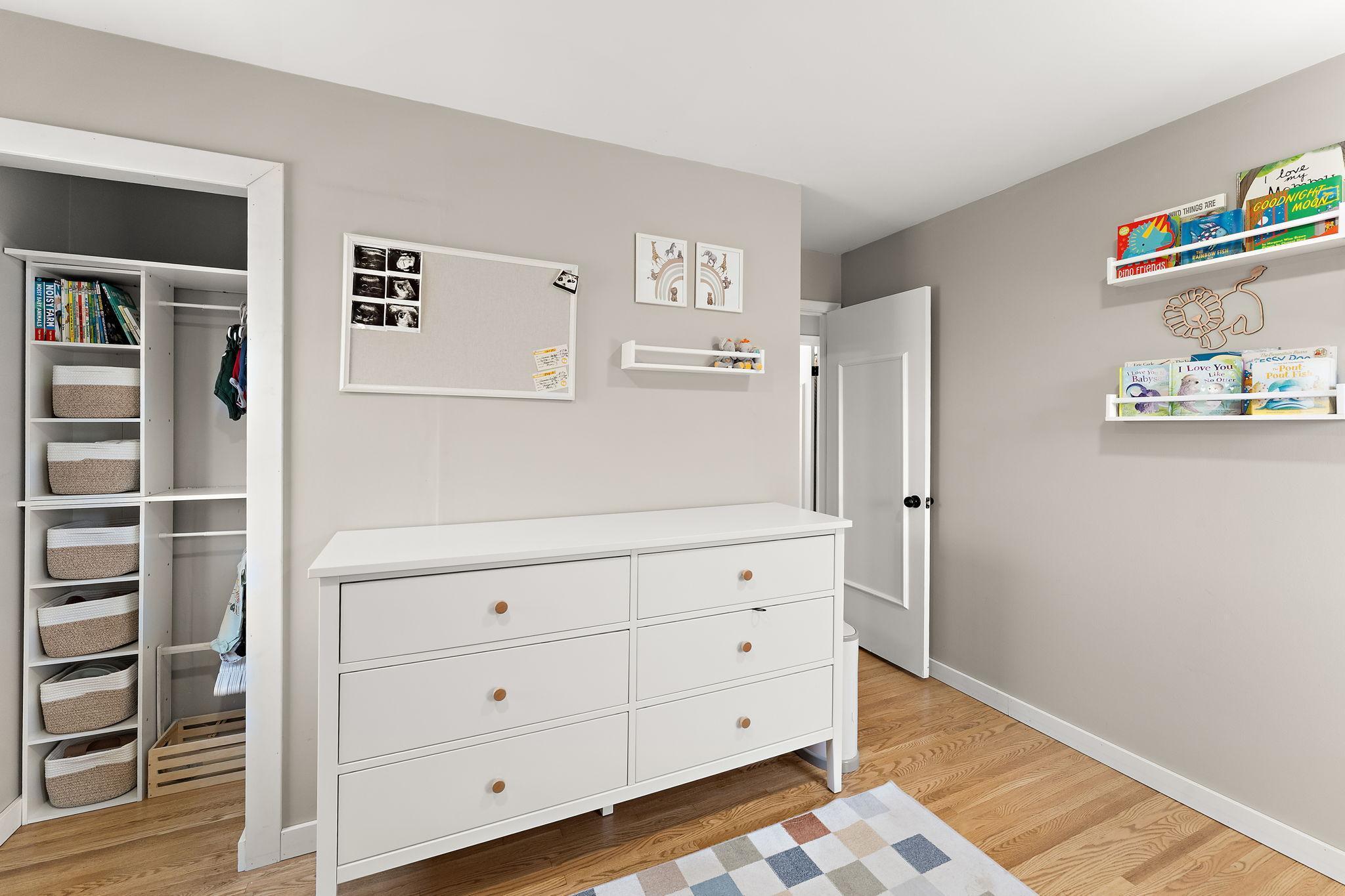 The main floor second bedroom features a large closet and a refinished hardwood floor.
