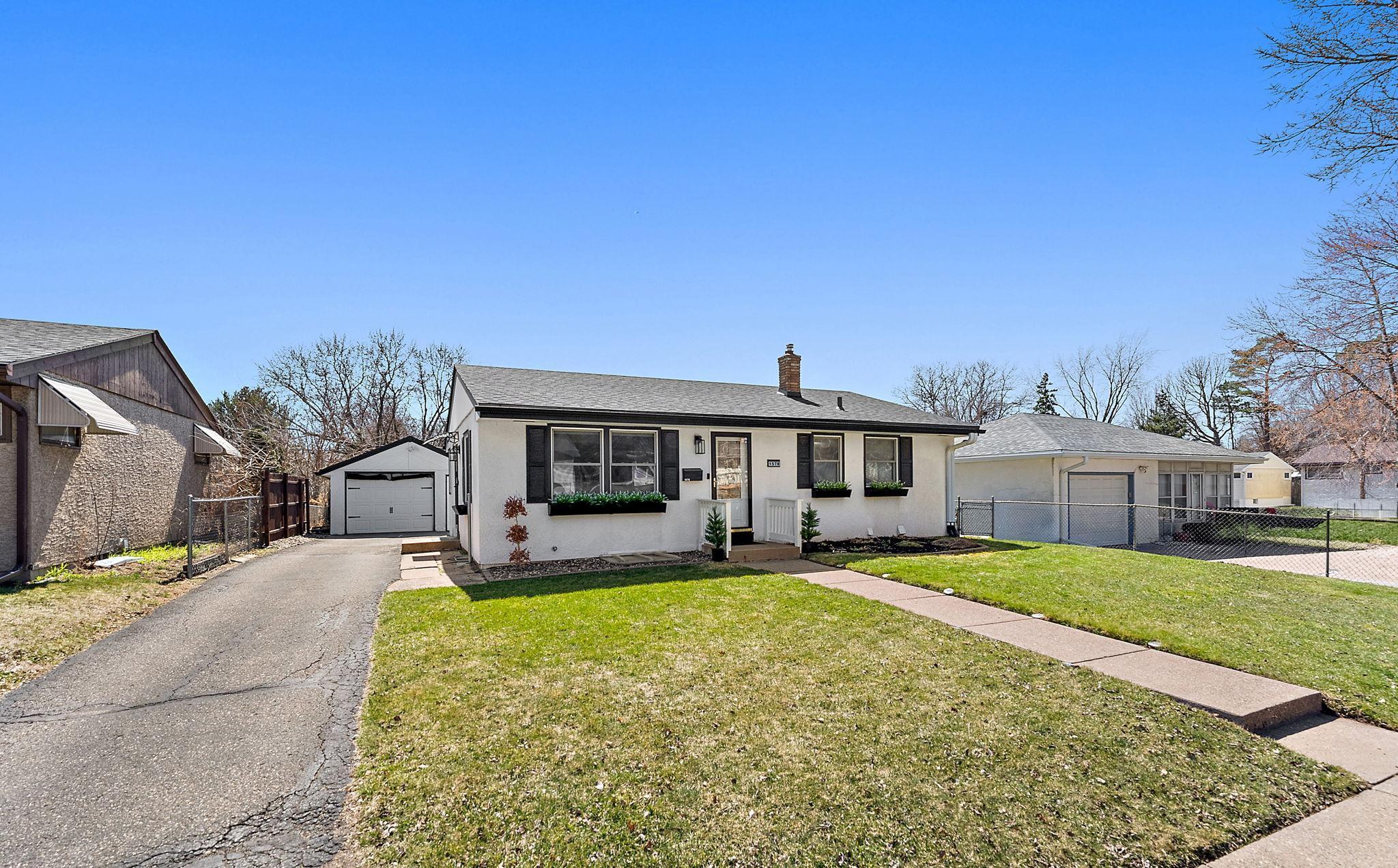 The property has a asphalt driveway and detached garage and charming curb appeal.
