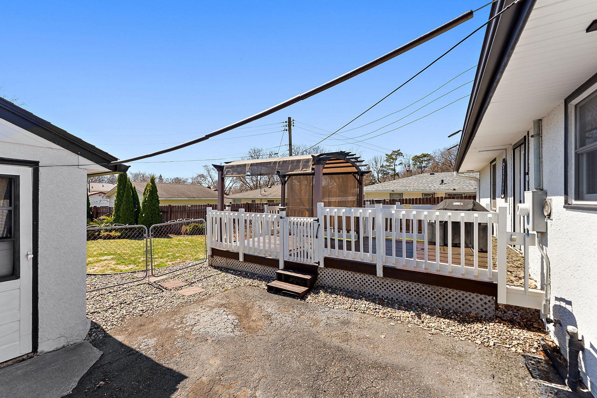 The back yard has a deck suitable for hosting outdoor barbecues and enjoying your own green space in private.