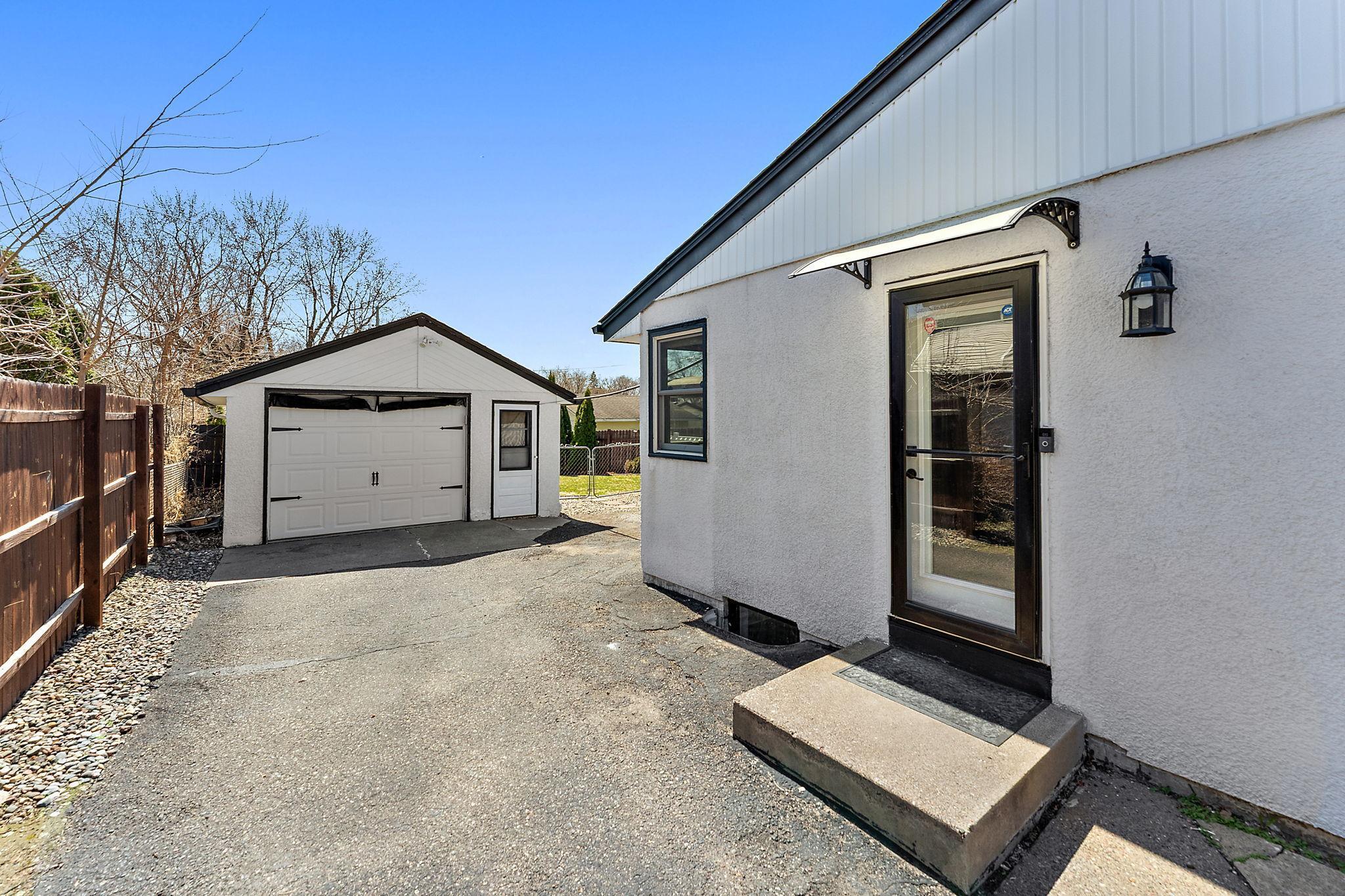 The property is enclosed with a wooden privacy fence and the garage is a close walk from the house. The garage also has a screen that fits the garage door. New Anderson windows installed in 2022 along with new exterior door.