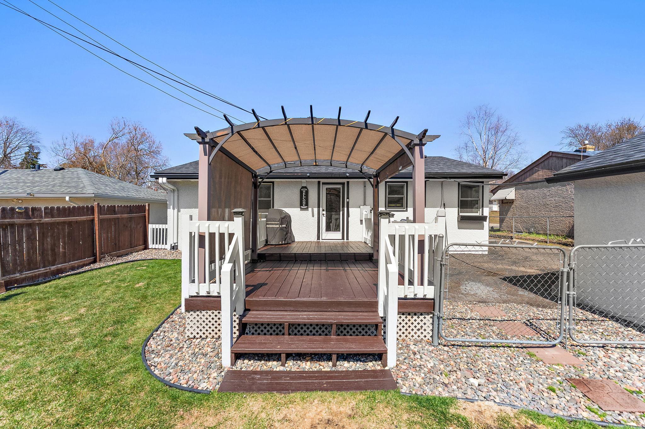 The feature of the backyard is this beautiful deck that has been recently stained and which has a pergola to provide shade on sunny days. Outside door replaced in 2022 along with new Anderson windows.