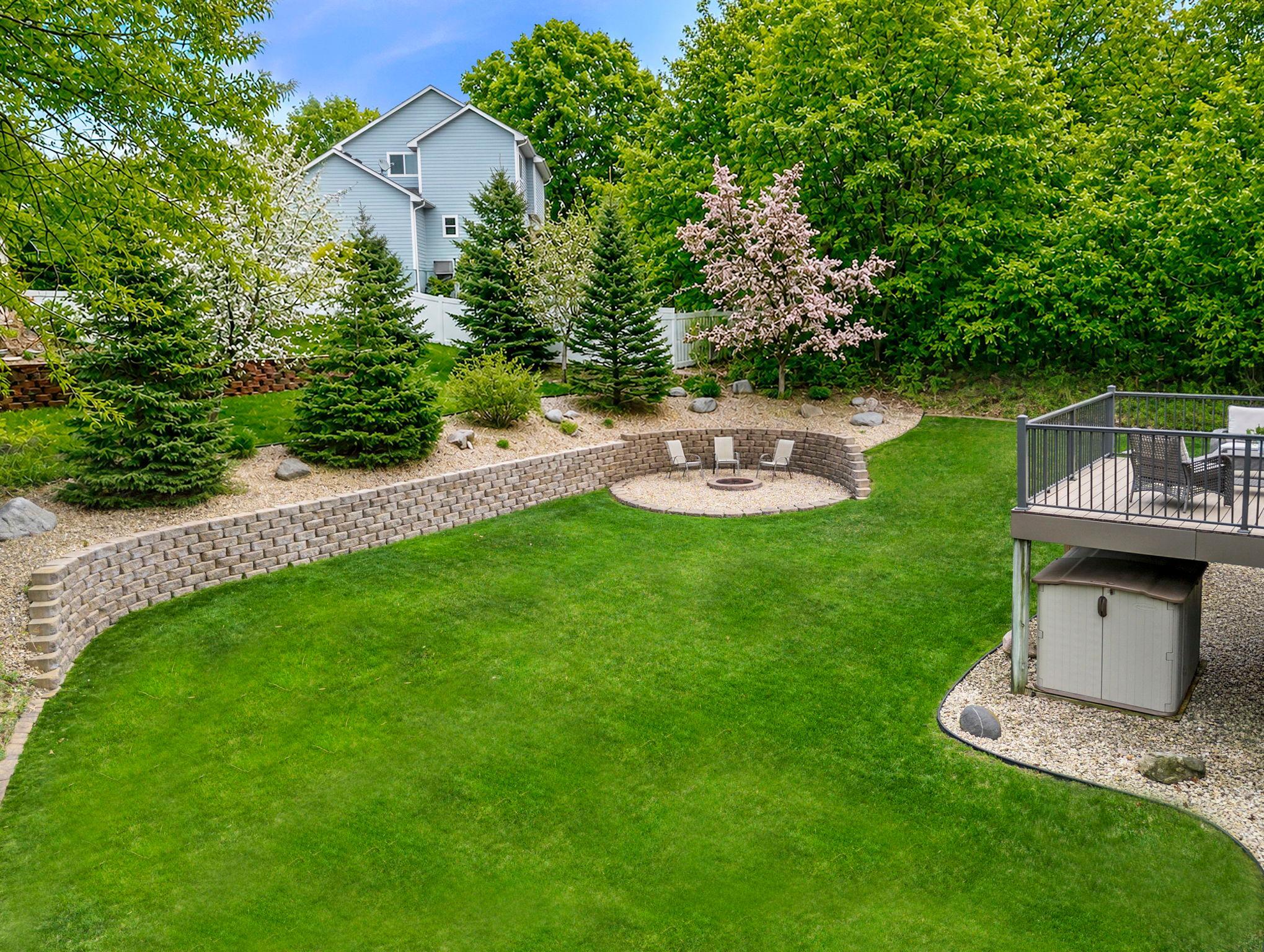 Gorgeous yard is lush in the summer and bright with color in the fall