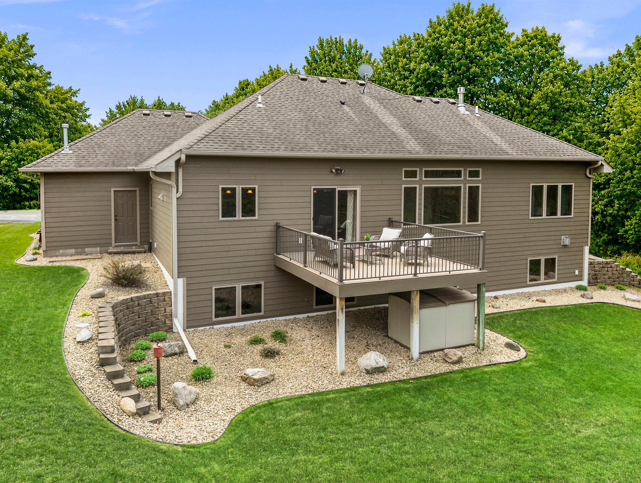 Well-designed backyard with retaining walls, a great deck area, and additional storage in the shed