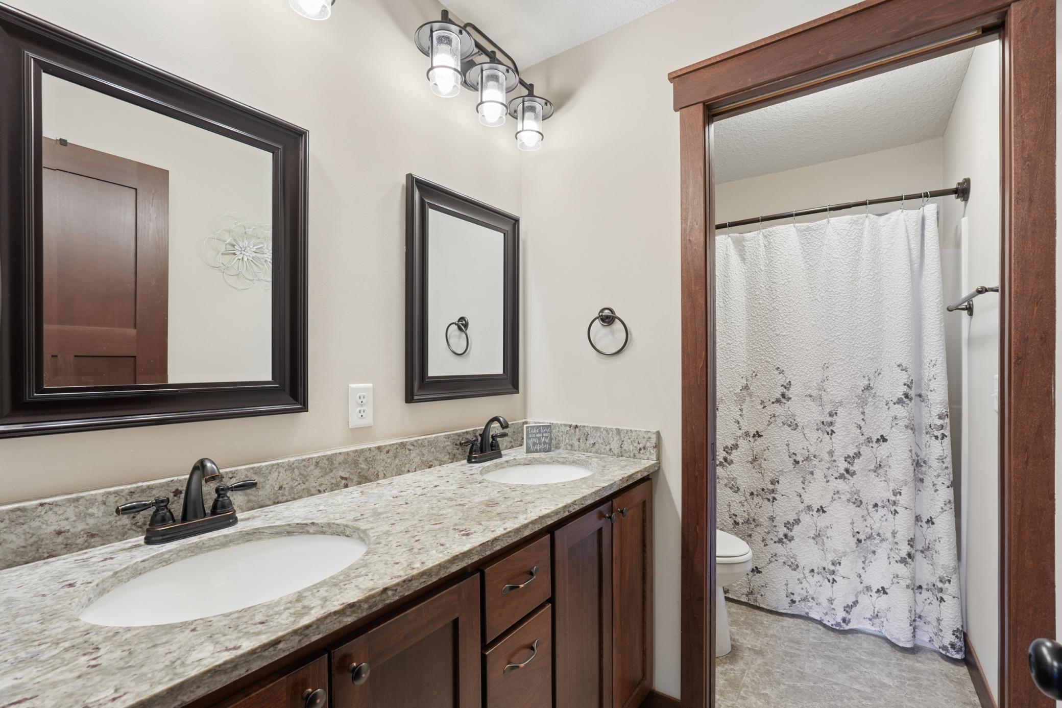 Centrally located top floor bathroom, complete with dual sink and separation from the tub, adds function on those busy mornings.