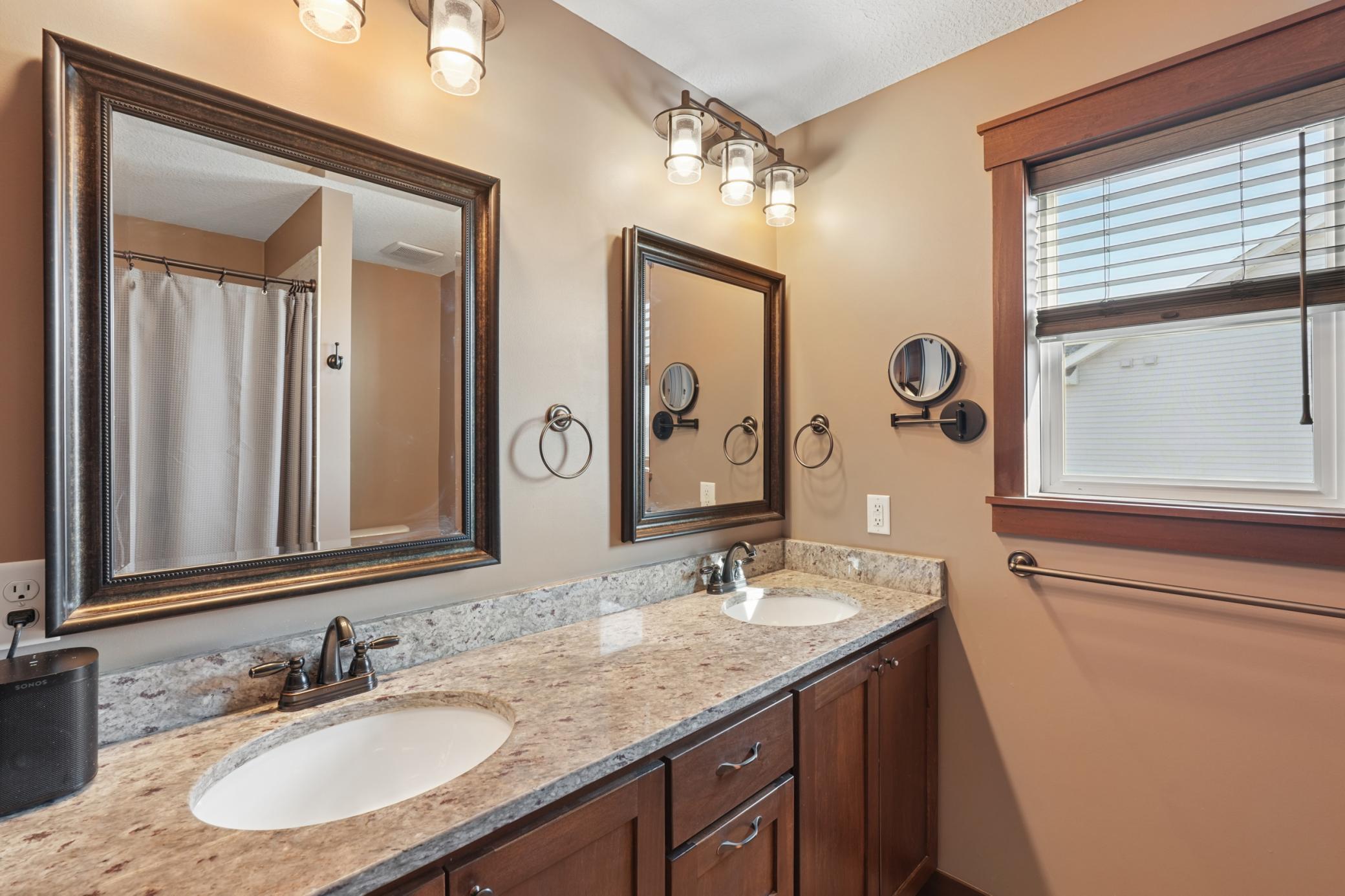 A private bath with a stunning tiled walk-in shower, and a double-bowl vanity that makes every morning effortless.