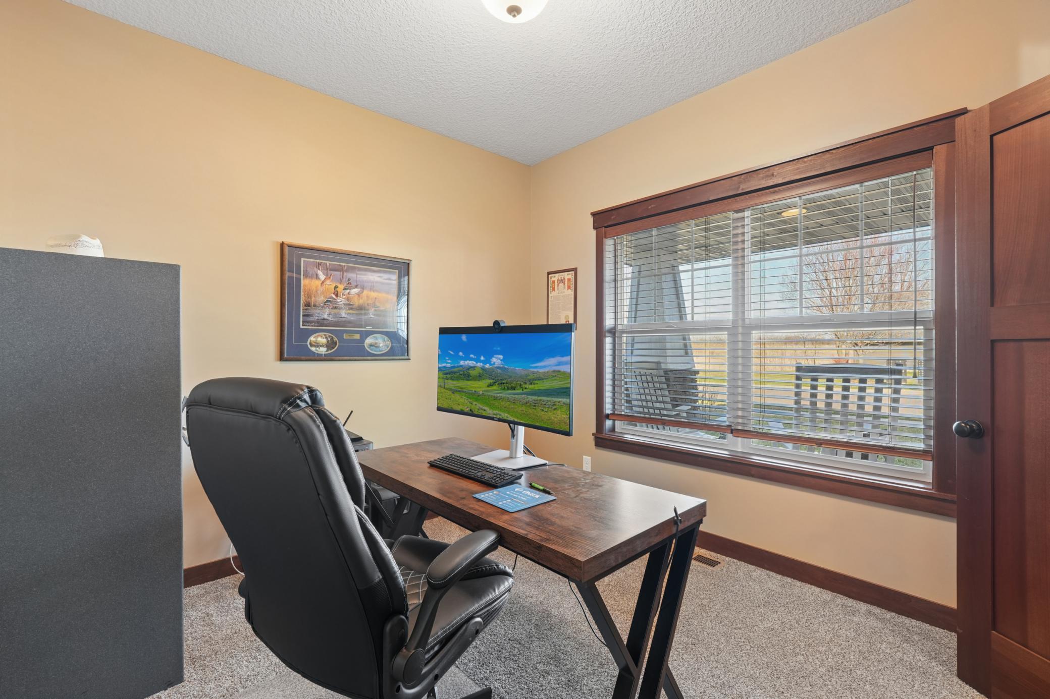A private office with classic French doors provides a quiet, professional workspace on the main level , ideal for today's work-from-home lifestyle.