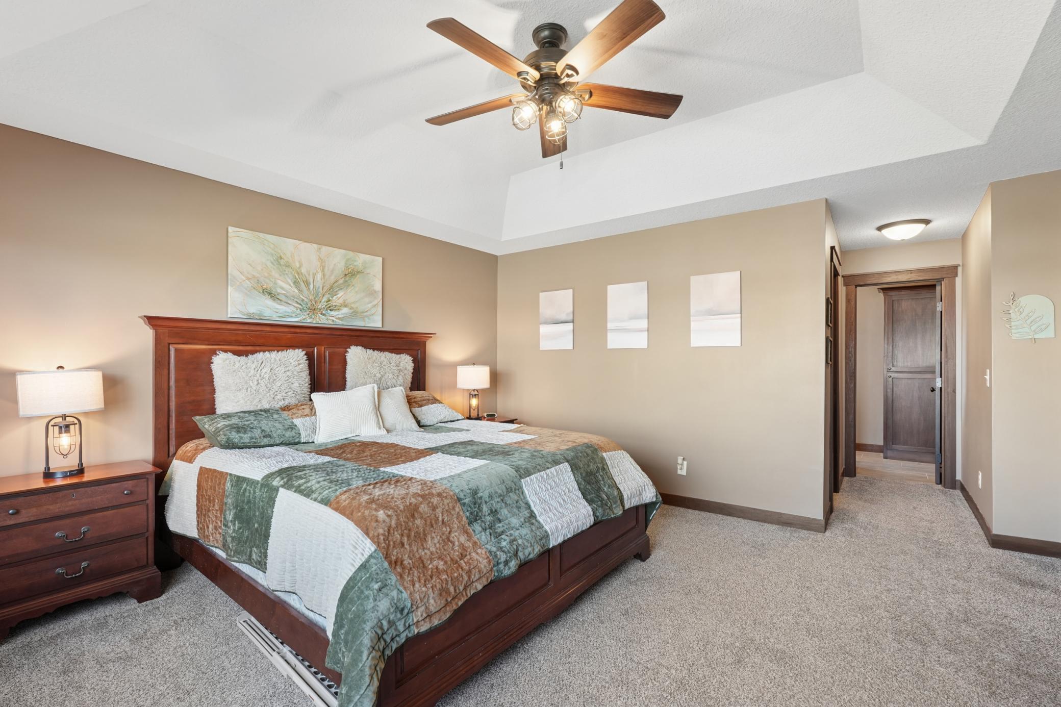 Escape to the luxurious primary suite, where dual walk-in closets, a spa-inspired tiled shower, and a beautifully appointed double vanity create a true owner's sanctuary.