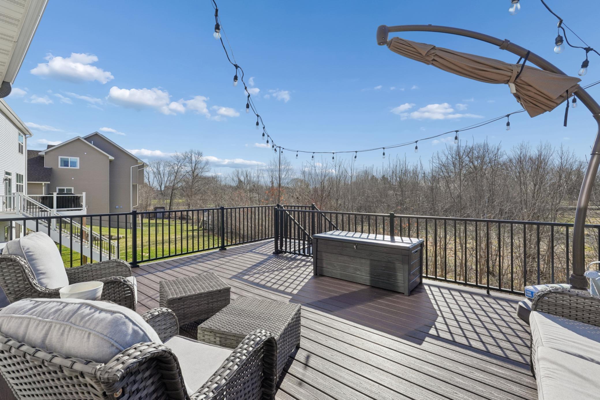 A spacious main-level deck overlooks the lush backyard