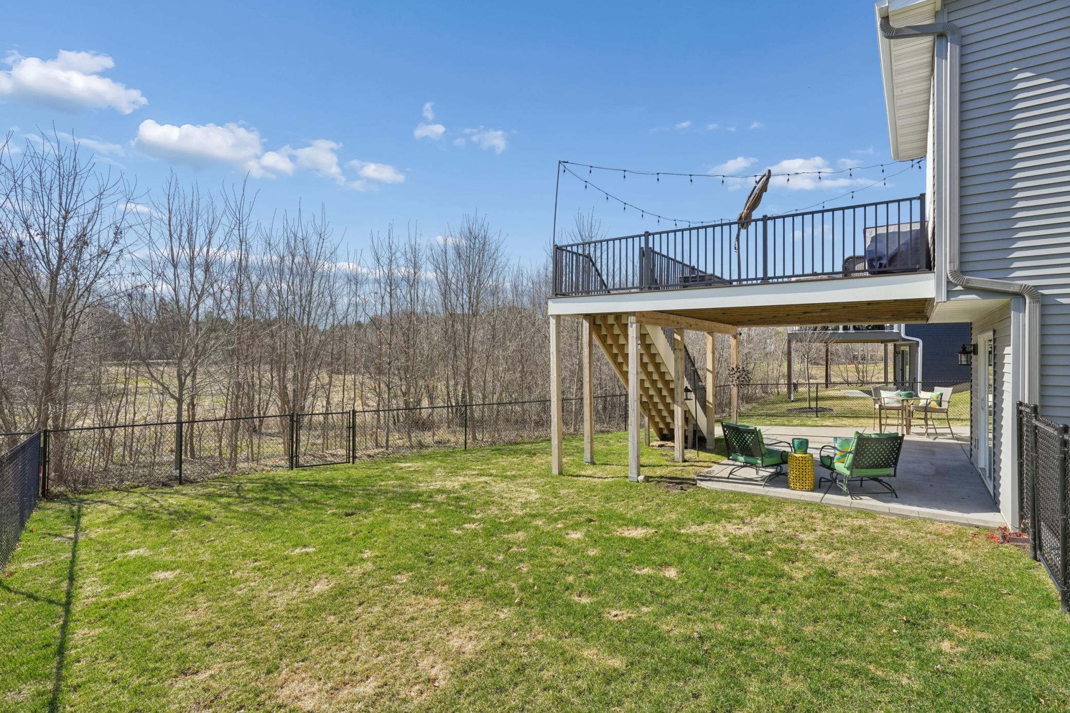 Serene backyard setting with no rear neighbors and in-ground sprinkler system for effortless care