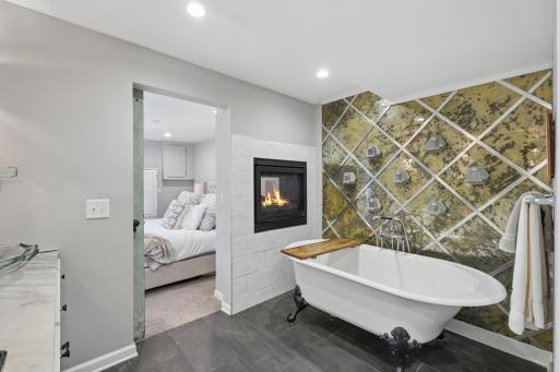 Soak in this super fun tub with the fireplace adding to the calm.