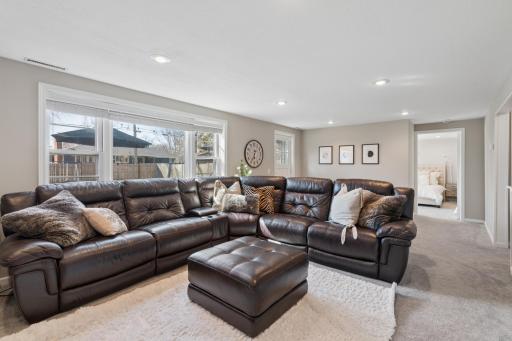 The basement family room has newer carpet and a large lookout window!