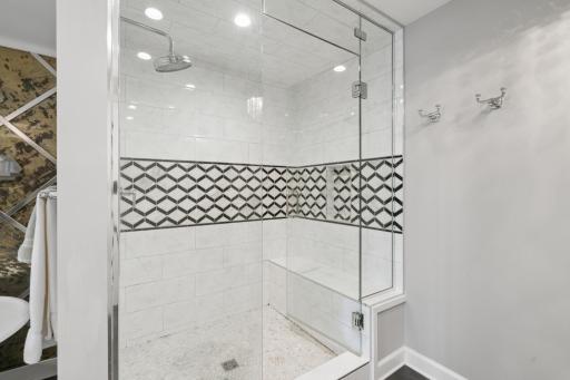 The walk in shower with a bench seat is such a wonderful addition to this bathroom.