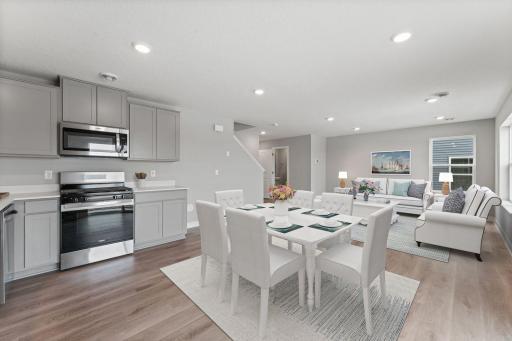 The open floor plan creates a space that seamlessly flows from kitchen and living space to your private outdoor living area. (Model photo, colors may vary)