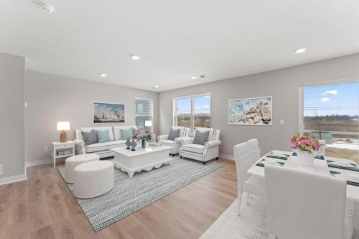 The main living space is open and full of light with an abundance of windows. (Model photo, colors may vary)