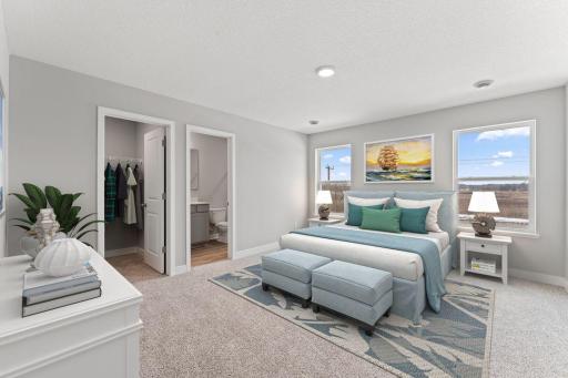 Beautiful primary bedroom upstairs with private en suite bathroom and walk-in closet. (Model photo, colors may vary)