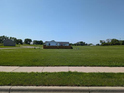 Sidewalks are already installed, saving the buyer $$ at time of new build. House to the south has fenced yard, offering you privacy without that cost!