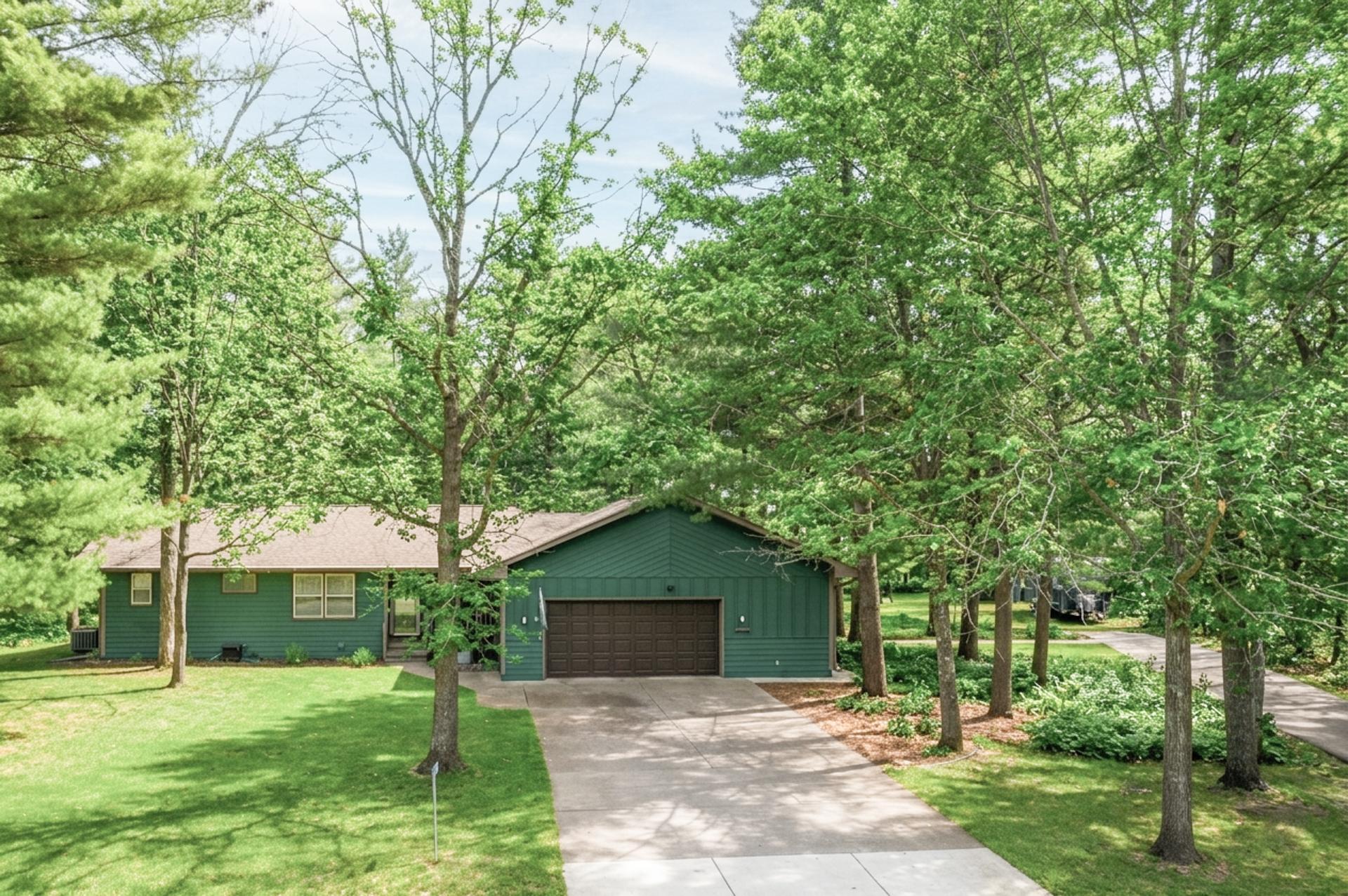 Welcoming exterior surrounded by mature trees and natural beauty.