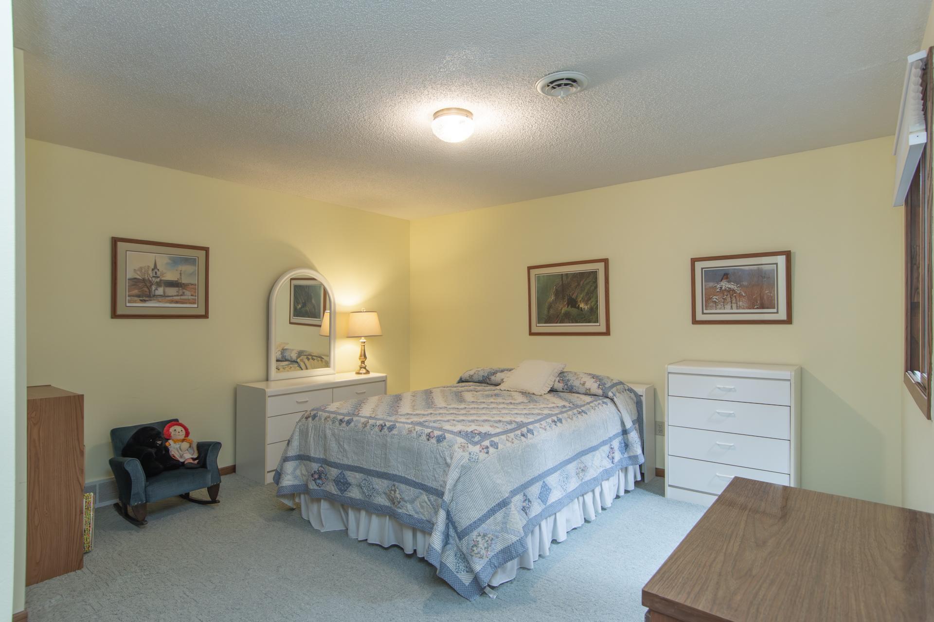 Lower level bedroom. Bright and comfortable spaces for family, guests, or a home office.