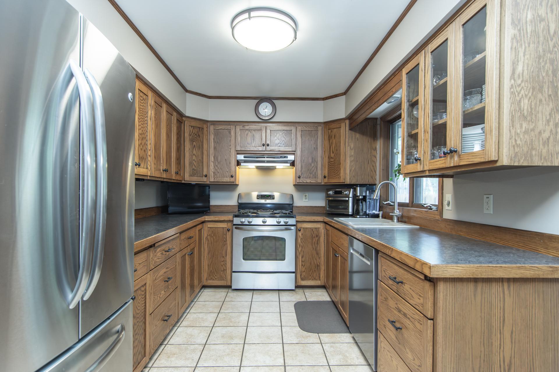 Bright kitchen with ample cabinetry and stainless steel appliances
