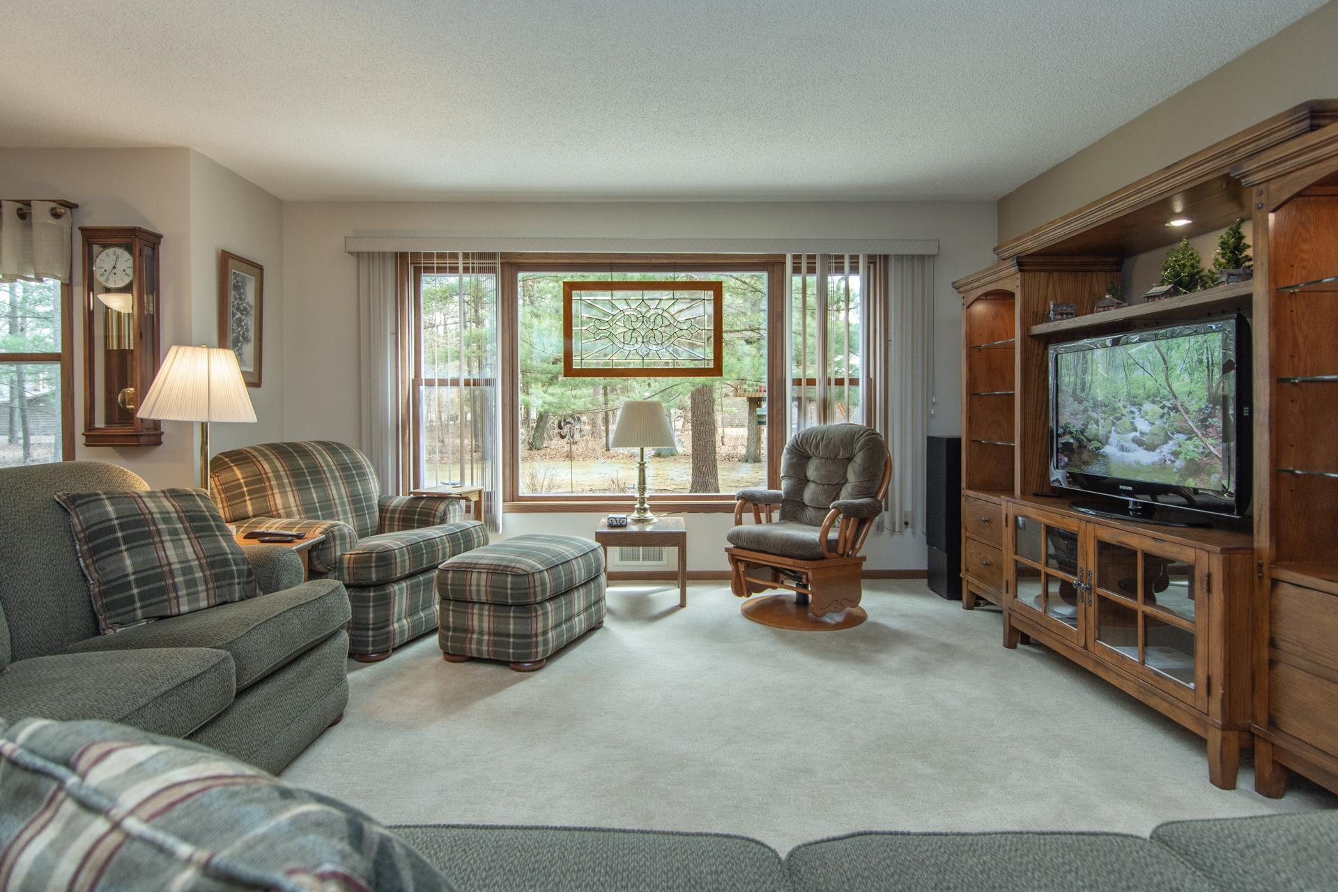 Spacious living room with abundant natural light.