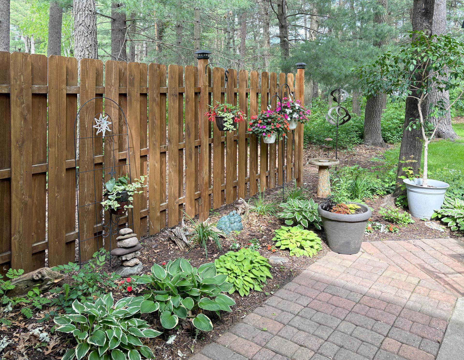 A lovely mix of flowers and greenery creates a serene outdoor retreat.