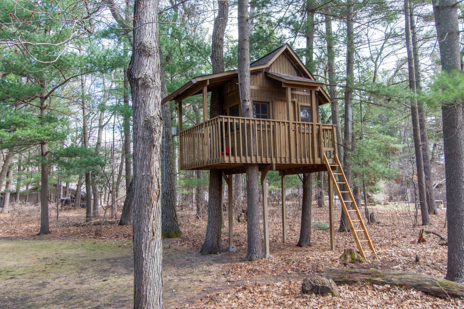 Tucked among mature trees, this treehouse adds character and charm to the backyard.